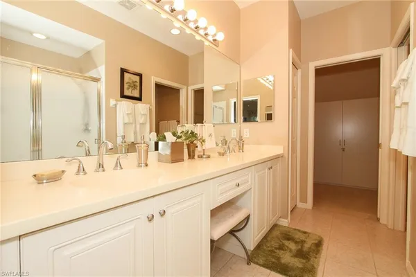 a bathroom with a sink double vanity and a mirror
