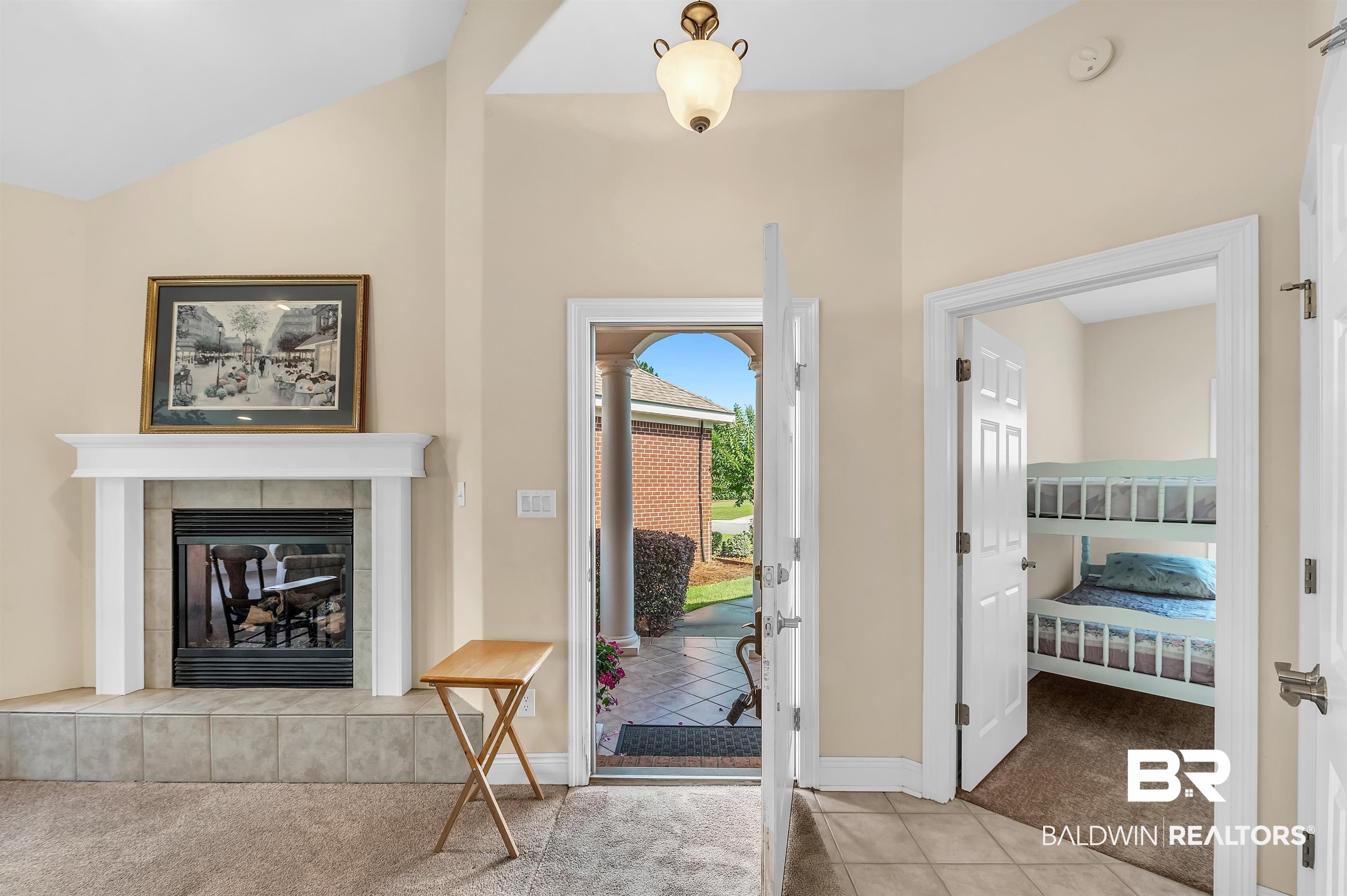 22739 Inverness Way Foley, AL 36535 - Photo 15 of 80 Carpeted entryway with a tile fireplace, baseboards, tile patterned flooring, and high vaulted ceiling