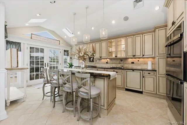 a kitchen with kitchen island granite countertop wooden cabinets and stainless steel appliances