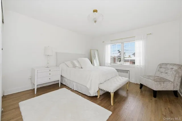 a bedroom with a bed and a chair in it