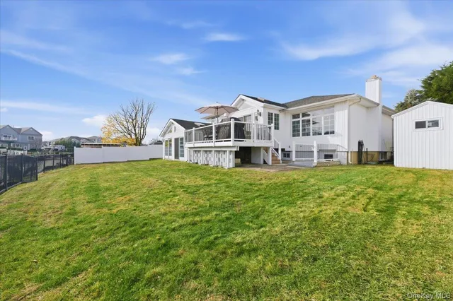 a front view of a house with a garden and plants
