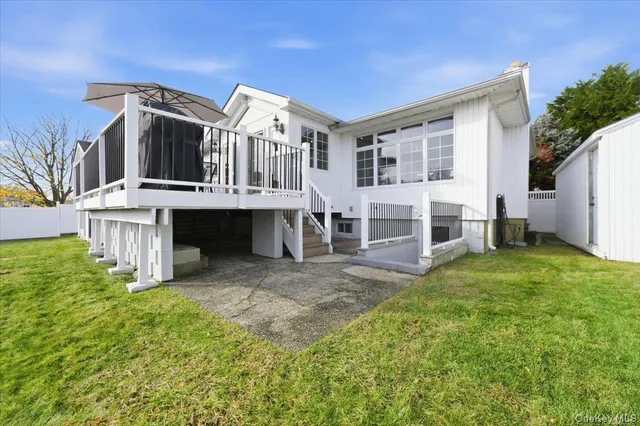 a view of a big house with a big yard and large trees