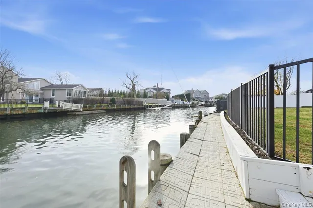 a view of a lake with boats in front of house
