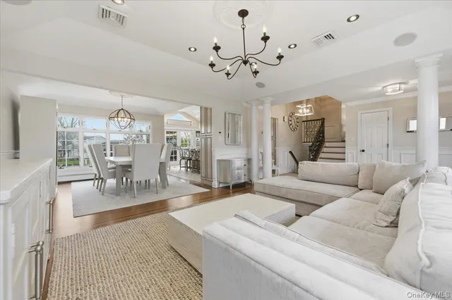 a living room with furniture and a chandelier