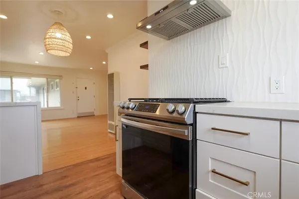a kitchen with a stove and a refrigerator