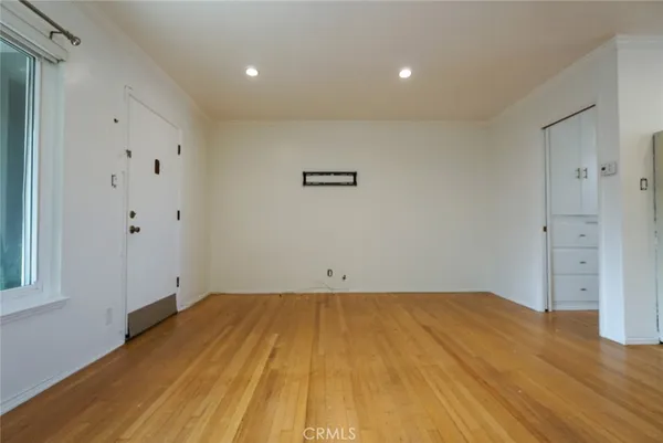 a view of room with wooden floor