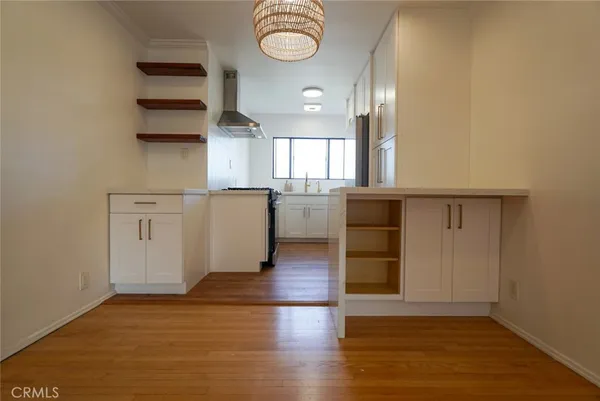 an empty room with wooden floor and window