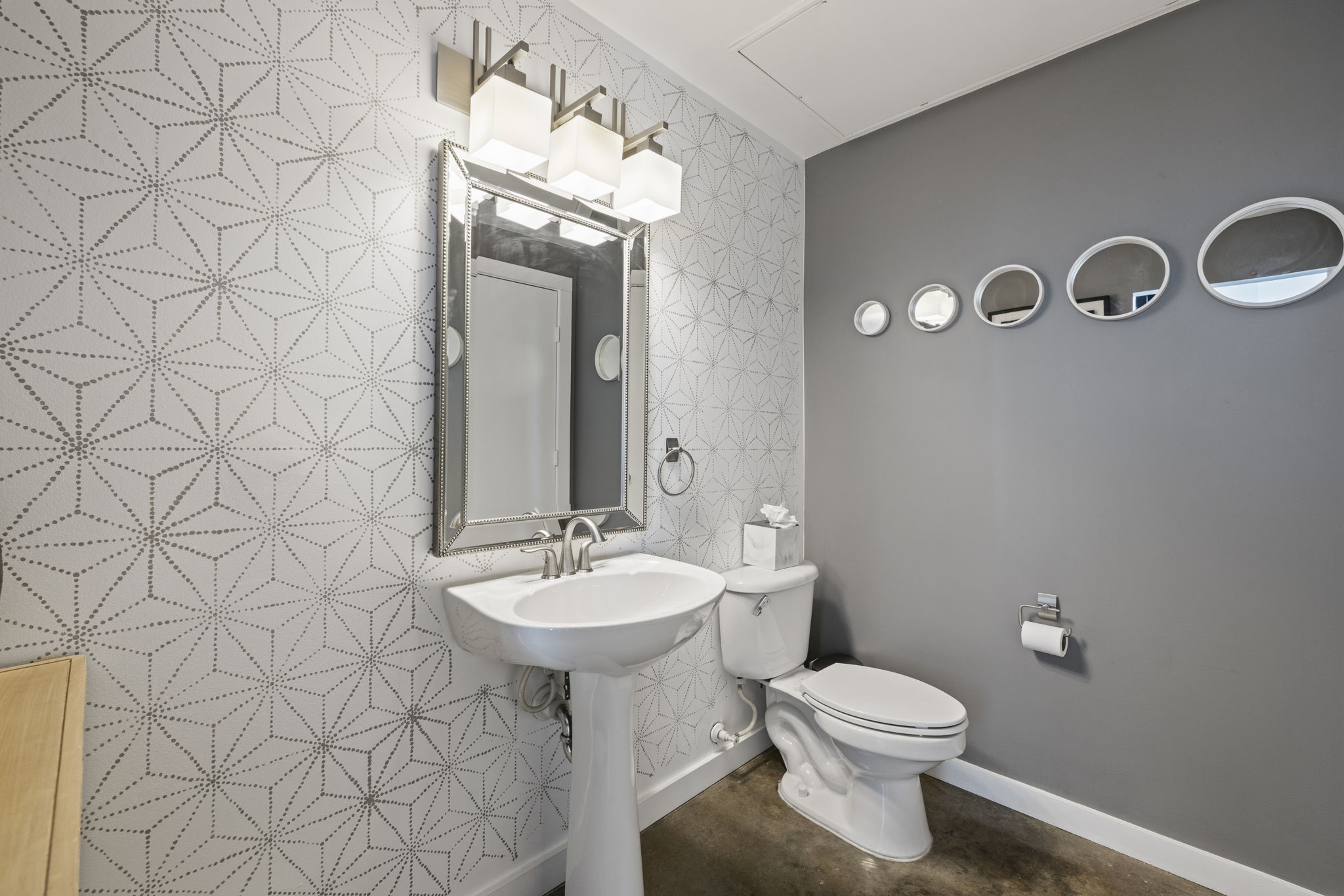 2000 Bagby Street, Unit 11415 Houston, TX 77002 - Photo 13 of 35 Designer-inspired 1st floor powder room features modern lighting, beveled mirror, and geometric accent painted walls. Laundry is located in powder room and has a full size Bosch washer & dryer. Additional built in shelving unit and storage closet for all of your storage needs.