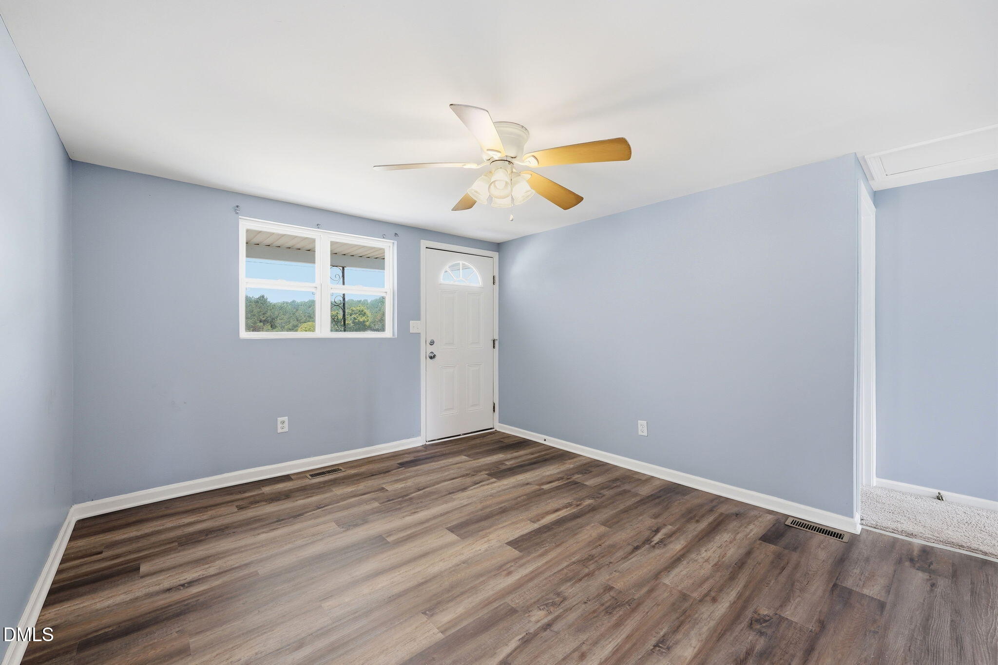 1758 Barber Mill Road Clayton, NC 27520 - Photo 6 of 41 an empty room with windows and fan
