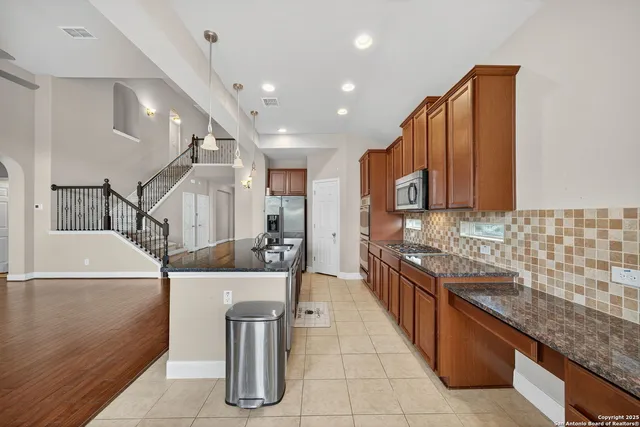 a kitchen with counter top space and stainless steel appliances
