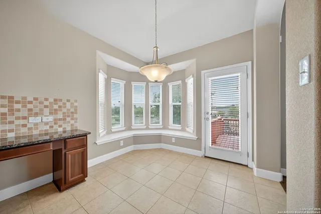 a open kitchen with granite countertop a sink and a stove top oven