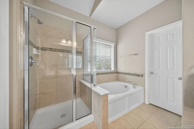 a bathroom with a tub shower and sink