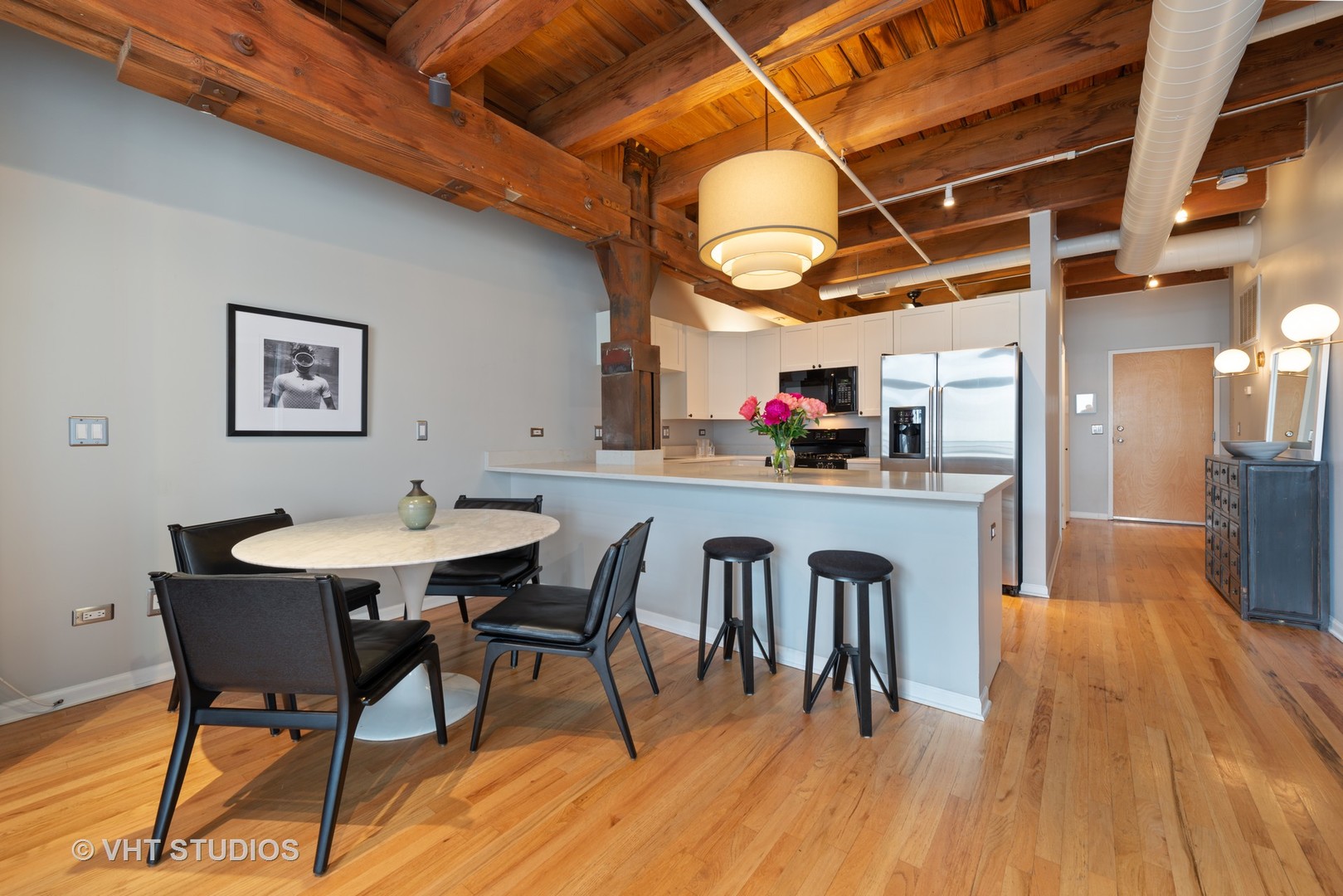 520 West Huron Street, Unit 208 Chicago, IL 60654 - Photo 4 of 14 a view of a dining room with furniture and wooden floor