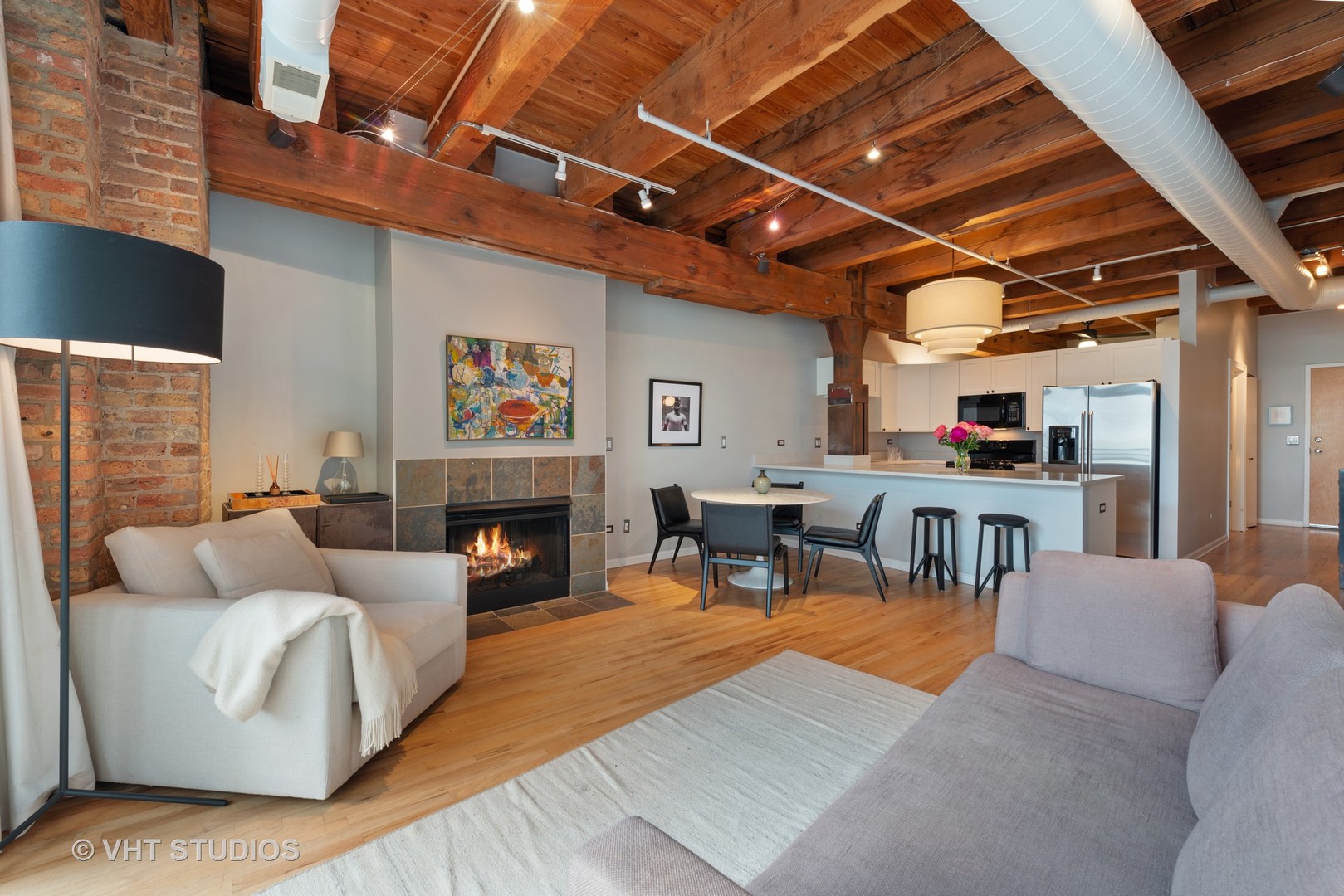 520 West Huron Street, Unit 208 Chicago, IL 60654 - Photo 5 of 14 a living room with furniture and a fireplace