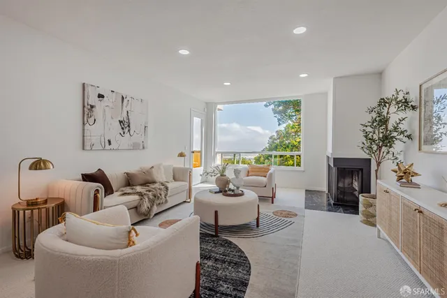 a living room with furniture large window and a fireplace