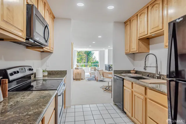a bathroom with a sink a toilet and a large mirror