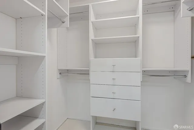 a bedroom with a bed and a potted plant