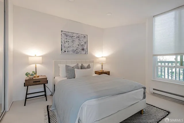 a bedroom with a large bed and a window