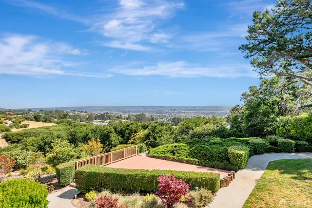 a front view of a building with a garden