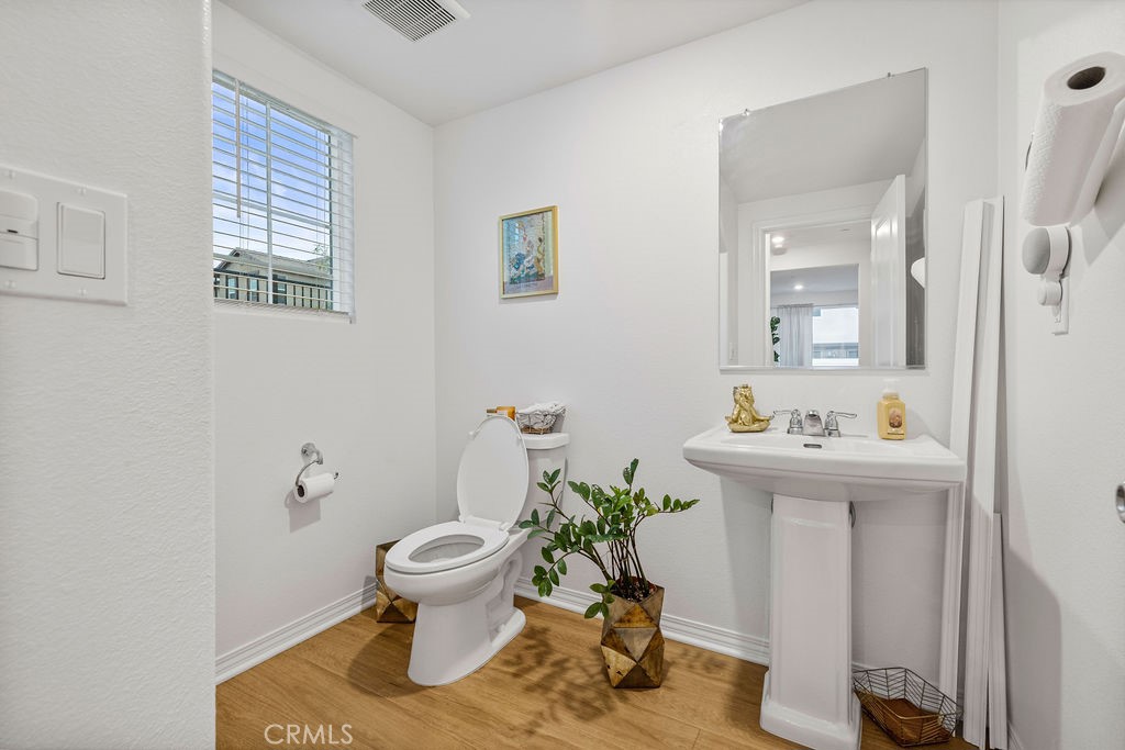 2522 Gunner Ridge Way Rialto, CA 92377 - Photo 12 of 40 a bathroom with a sink toilet and a mirror