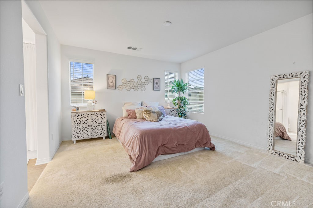 2522 Gunner Ridge Way Rialto, CA 92377 - Photo 14 of 40 a bedroom with a bed and a window