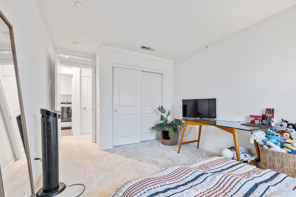 2522 Gunner Ridge Way Rialto, CA 92377 - Photo 19 of 40 a bedroom with furniture and a flat screen tv