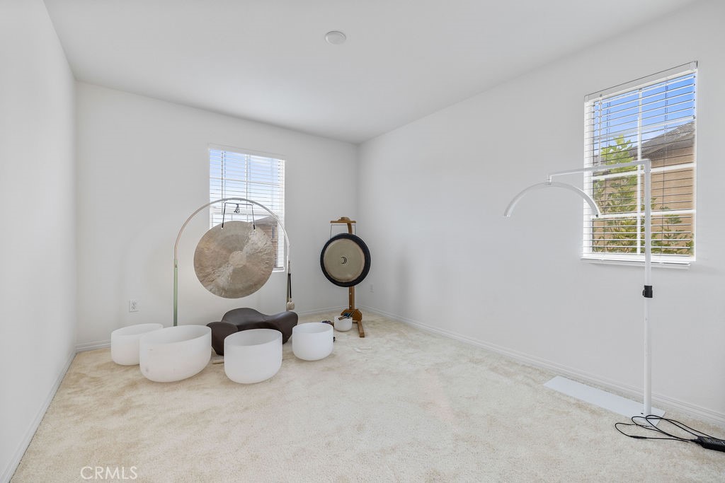 2522 Gunner Ridge Way Rialto, CA 92377 - Photo 20 of 40 a view of a room with racks on the wall clock and a window