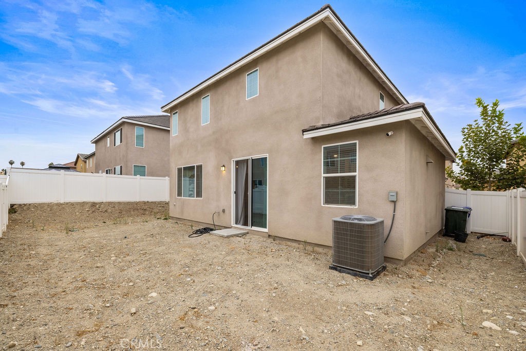 2522 Gunner Ridge Way Rialto, CA 92377 - Photo 24 of 40 a view of house with backyard and glass windows