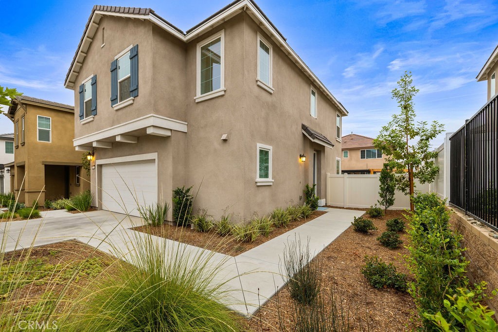 2522 Gunner Ridge Way Rialto, CA 92377 - Photo 4 of 40 a front view of a house with a yard