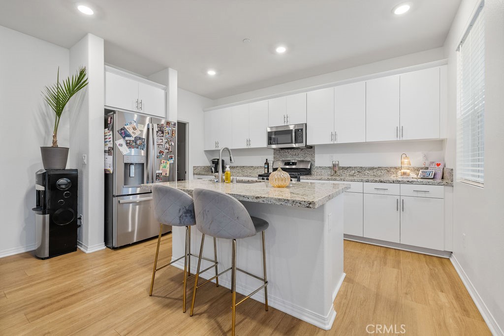 2522 Gunner Ridge Way Rialto, CA 92377 - Photo 7 of 40 a kitchen with stainless steel appliances granite countertop a refrigerator sink and cabinets