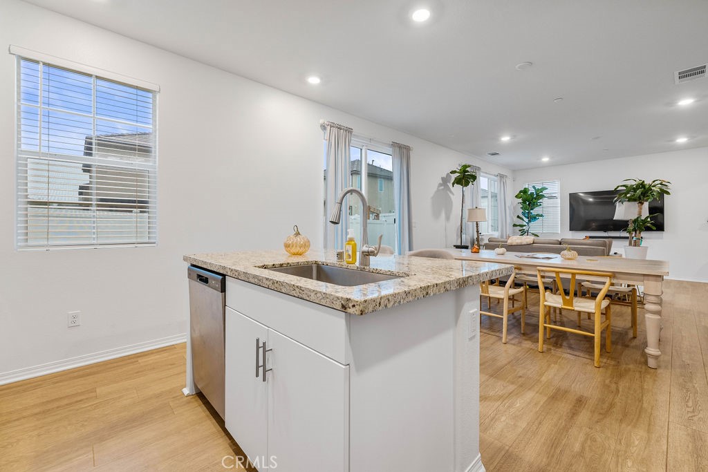 2522 Gunner Ridge Way Rialto, CA 92377 - Photo 9 of 40 a kitchen with stainless steel appliances granite countertop a stove and a sink