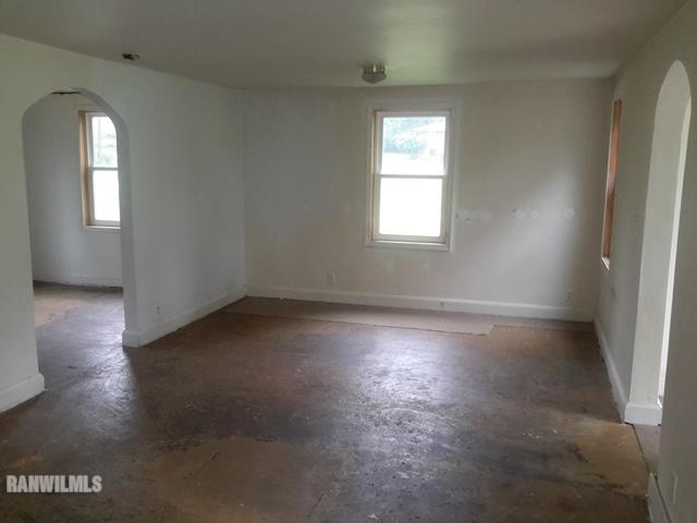 4422 Broadview Road Rockford, IL 61101 - Photo 4 of 25 an empty room with wooden floor and windows