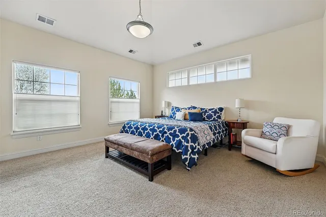 a bedroom with a bed and a couch