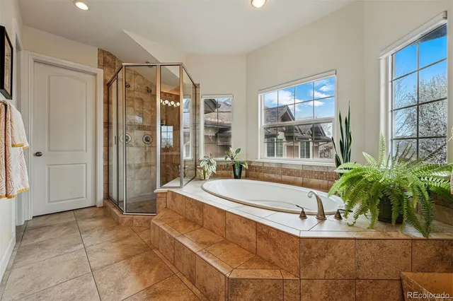 a bathroom with a tub shower and sink