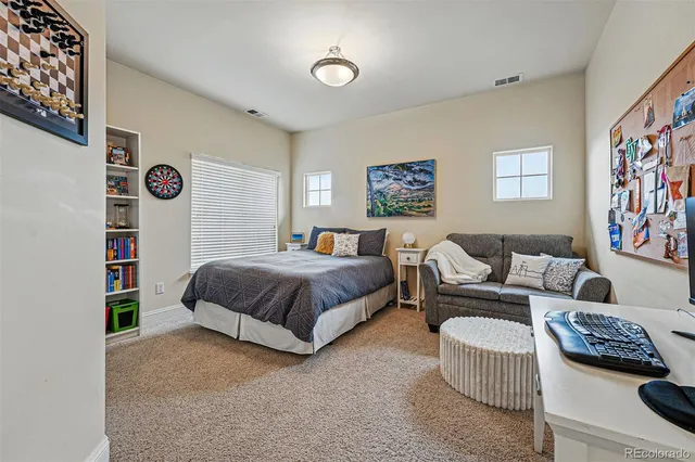 a spacious bedroom with a bed and a couch