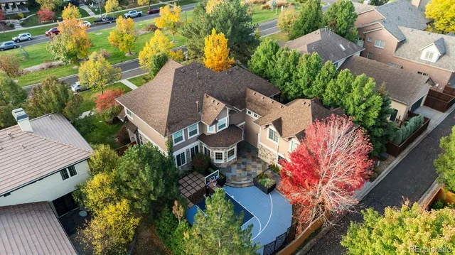 an aerial view of a house with a yard basket ball court and outdoor seating