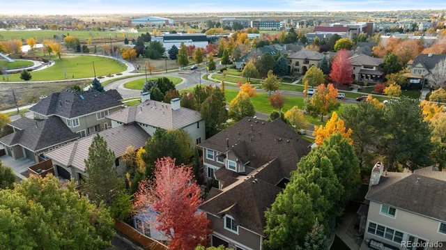 an aerial view of a houses with a swimming pool