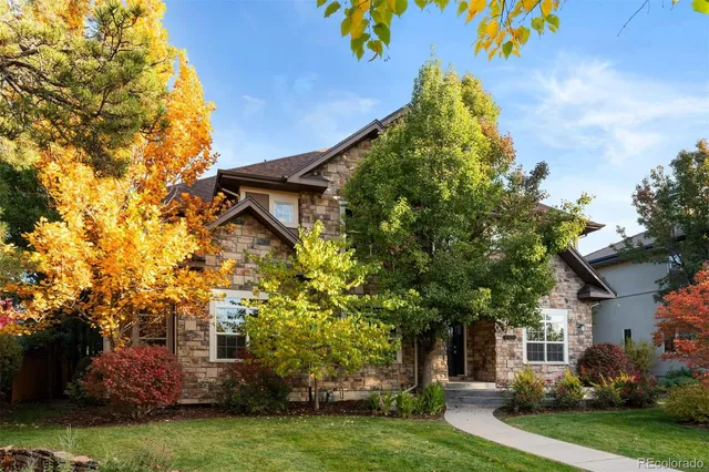 front view of a house with a tree