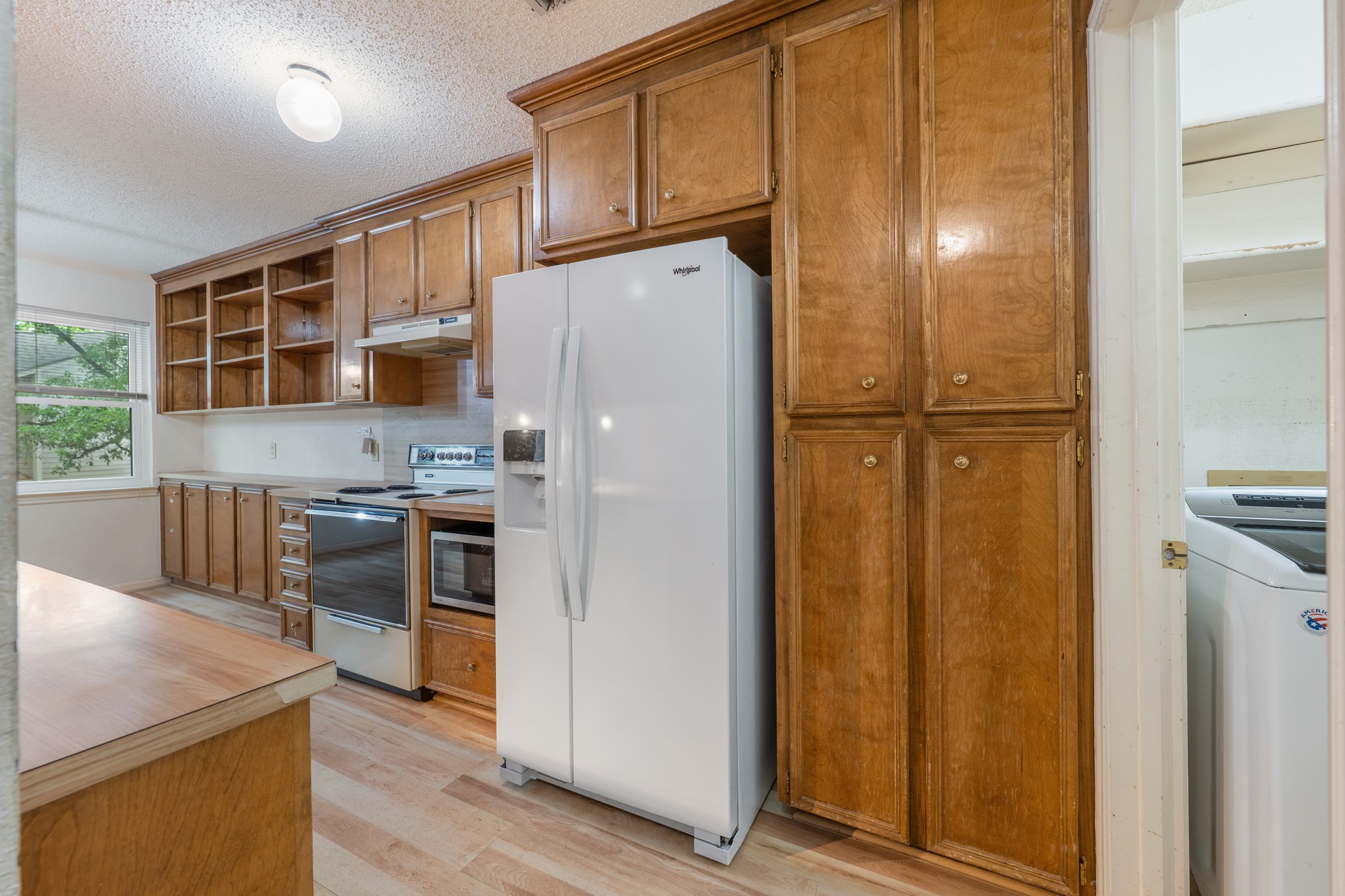 3845 Ranch Road 2222, Unit 19 Austin, TX 78731 - Photo 15 of 38 a kitchen with stainless steel appliances a refrigerator and a stove top oven