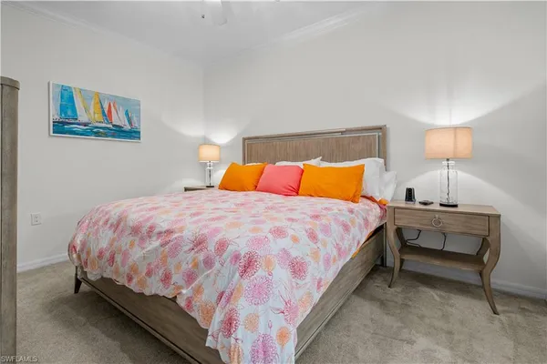 a large bed sitting in a bedroom with a lamp