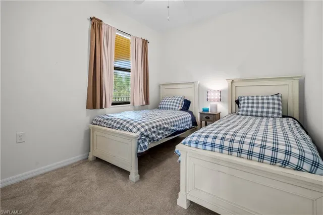 a bedroom with two beds and a window