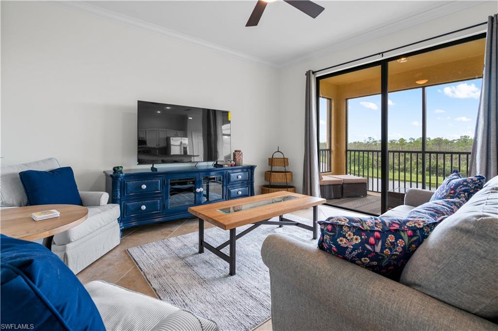 9735 Acqua Court, Unit 641 Naples, FL 34113 - Photo 2 of 34 a living room with furniture and a flat screen tv
