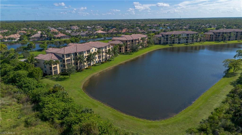 9735 Acqua Court, Unit 641 Naples, FL 34113 - Photo 22 of 34 an aerial view of a house with a garden and lake view
