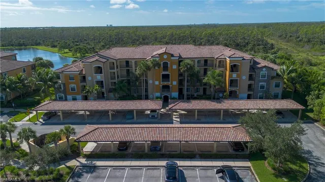 an aerial view of a house with a garden and lake view
