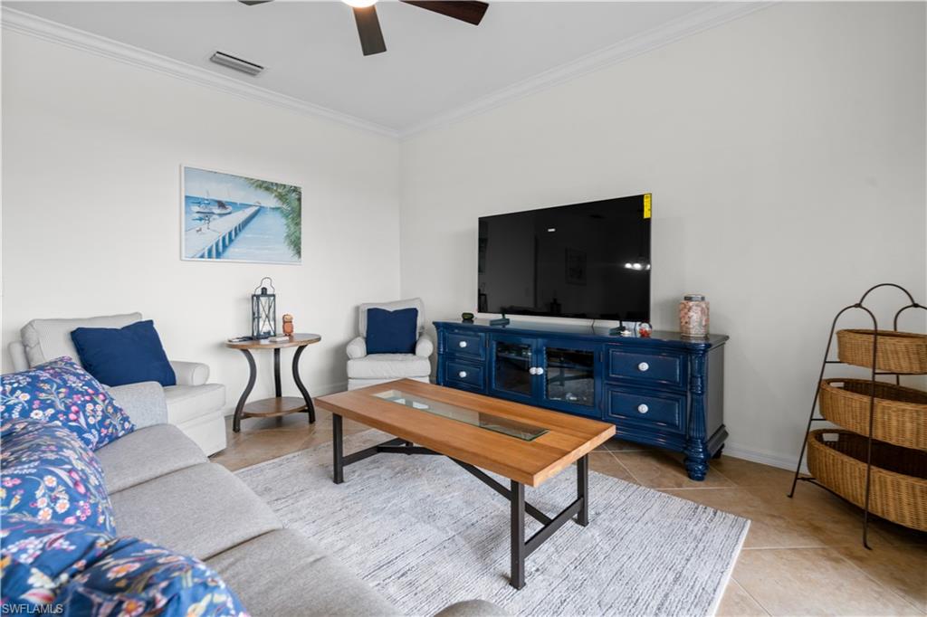 9735 Acqua Court, Unit 641 Naples, FL 34113 - Photo 3 of 34 a living room with furniture and a flat screen tv