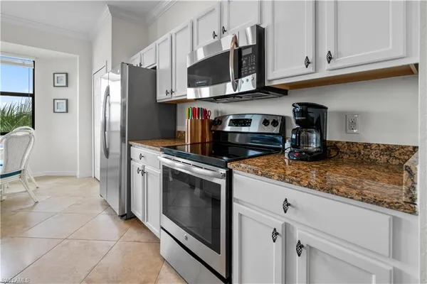 a kitchen with stainless steel appliances granite countertop a refrigerator stove and sink