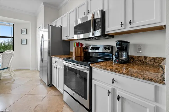 a kitchen with stainless steel appliances granite countertop a refrigerator stove and sink
