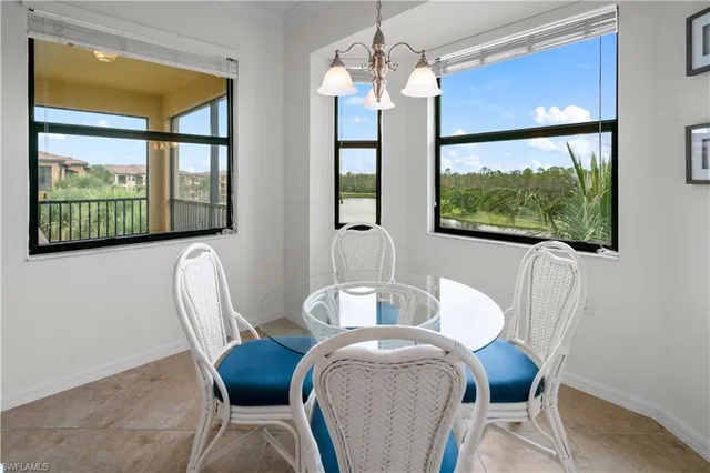 a view of a dining room with furniture large windows and wooden floor
