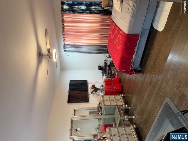 177 Maple Street Fairview, NJ 07022 - Photo 6 of 24 a bedroom with a bed and flat tv screen on dresser