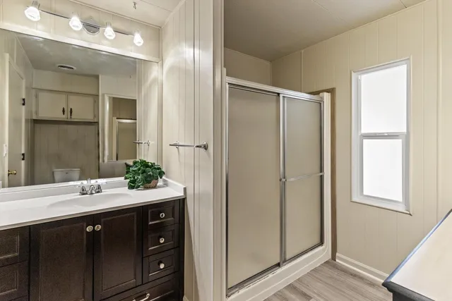 a bedroom with a bed and a ceiling fan